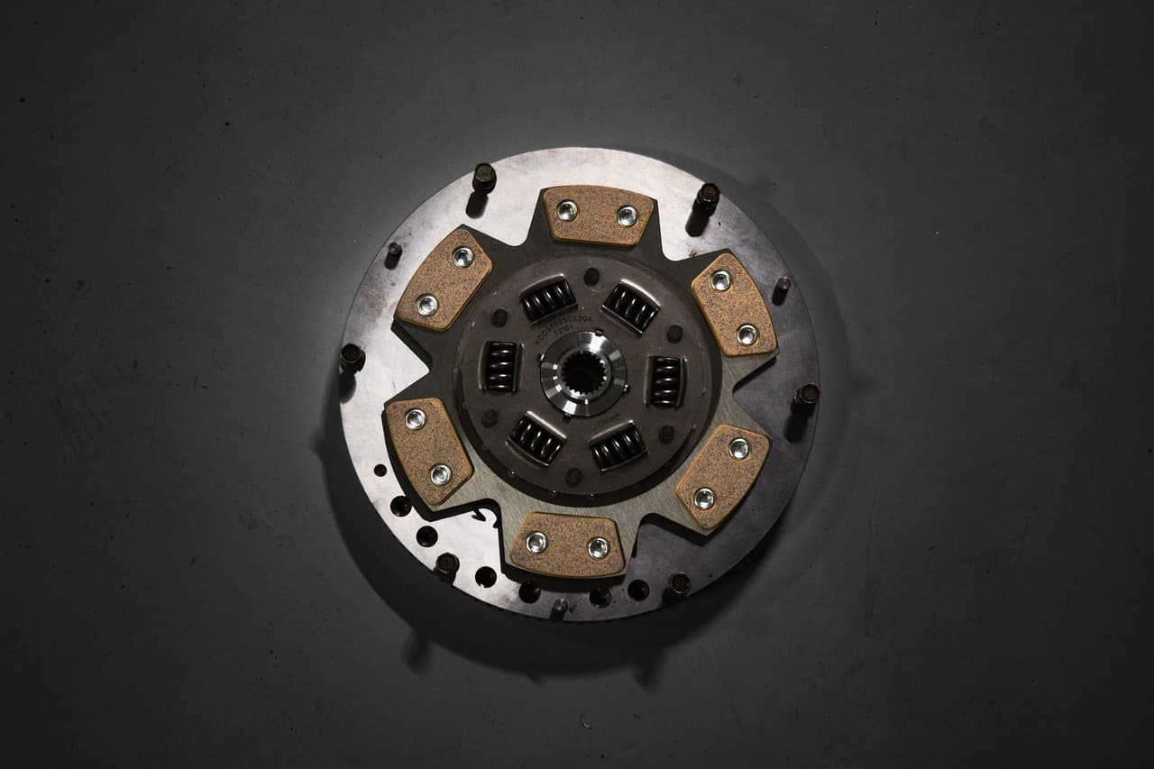 A clutch plate on a dark surface