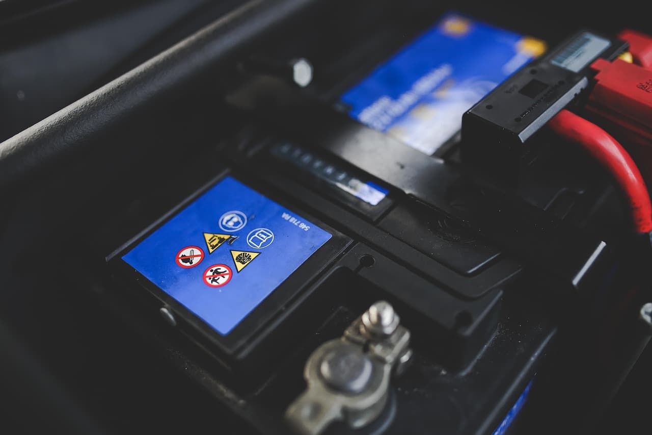 A car battery and its terminal under the bonnet